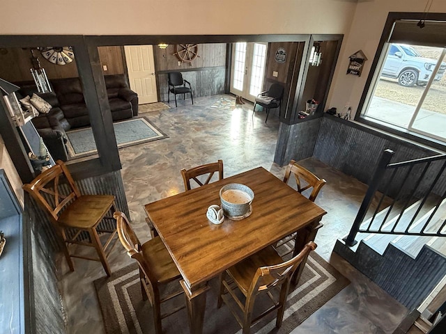 dining area featuring a wainscoted wall and french doors