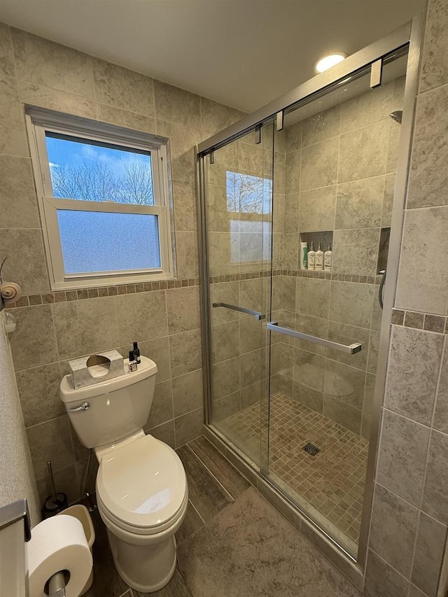 bathroom featuring a stall shower and toilet