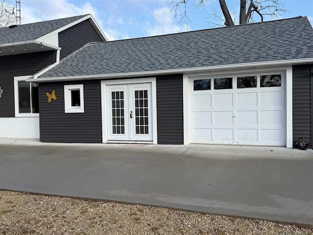 garage with french doors and driveway