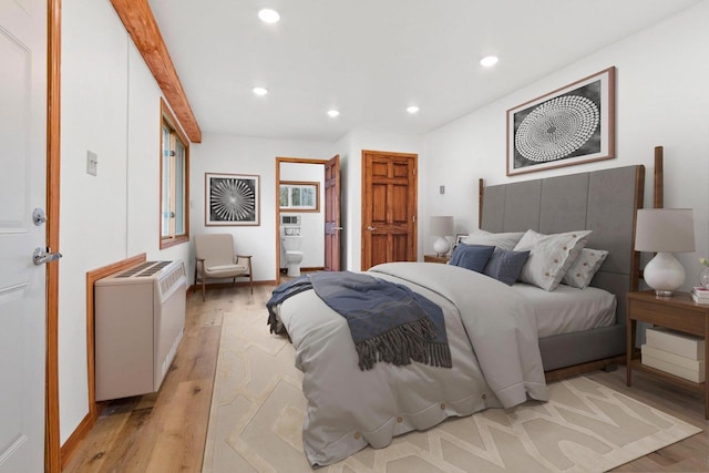 bedroom with baseboards, light wood-type flooring, ensuite bath, and recessed lighting