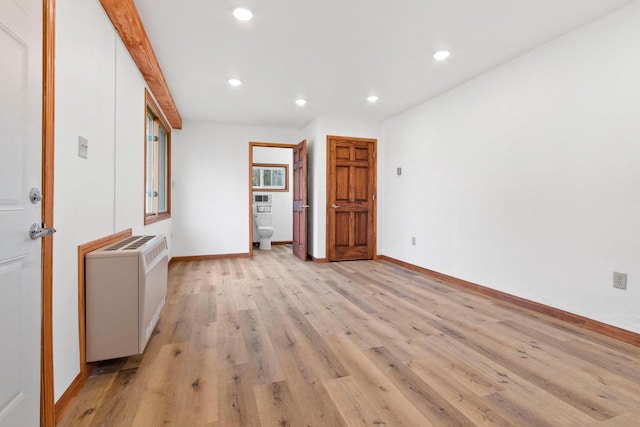 unfurnished room with recessed lighting, baseboards, light wood finished floors, and radiator heating unit