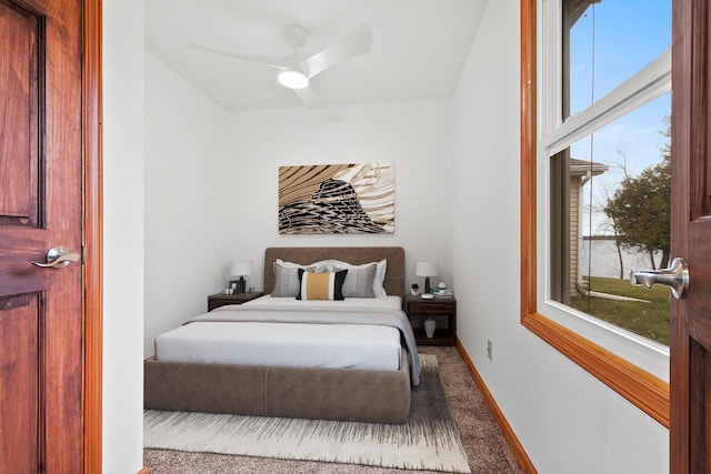 bedroom with carpet flooring, a ceiling fan, and baseboards