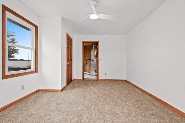 unfurnished room featuring ceiling fan, baseboards, and light colored carpet