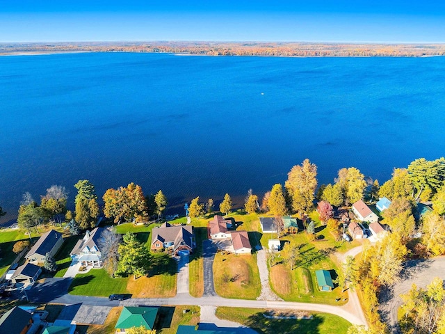 drone / aerial view with a water view and a residential view