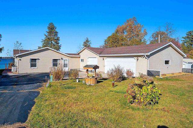 ranch-style house with an attached garage and a front lawn