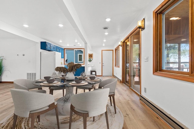 dining room with recessed lighting, a baseboard radiator, visible vents, and light wood-style floors