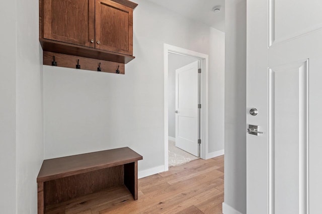 mudroom with light wood-style floors and baseboards