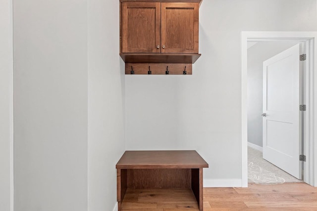 mudroom with light wood-type flooring and baseboards