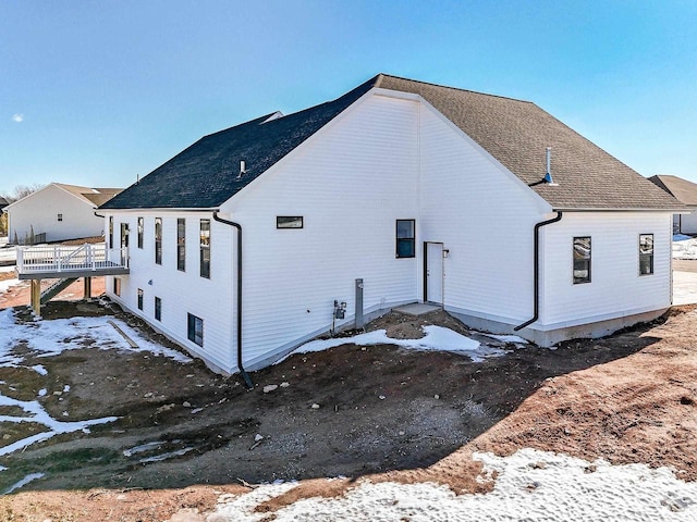 exterior space with a shingled roof