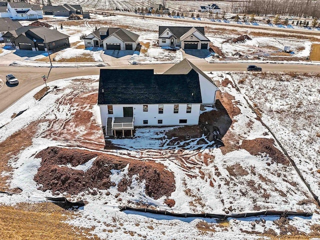 snowy aerial view with a residential view