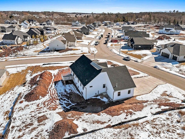 snowy aerial view featuring a residential view