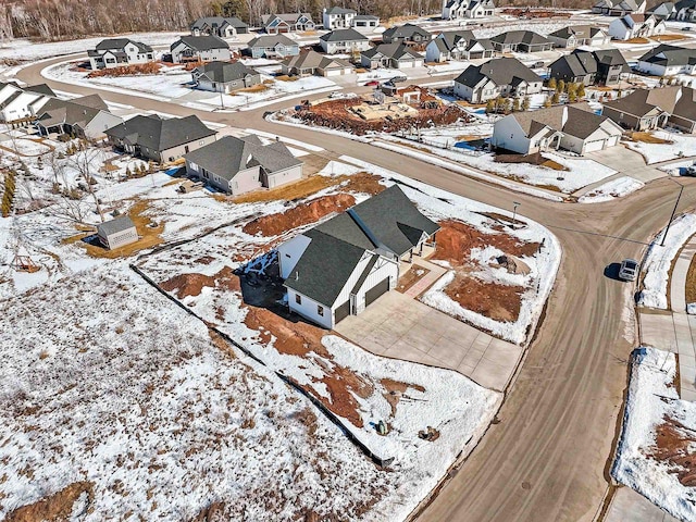 snowy aerial view featuring a residential view