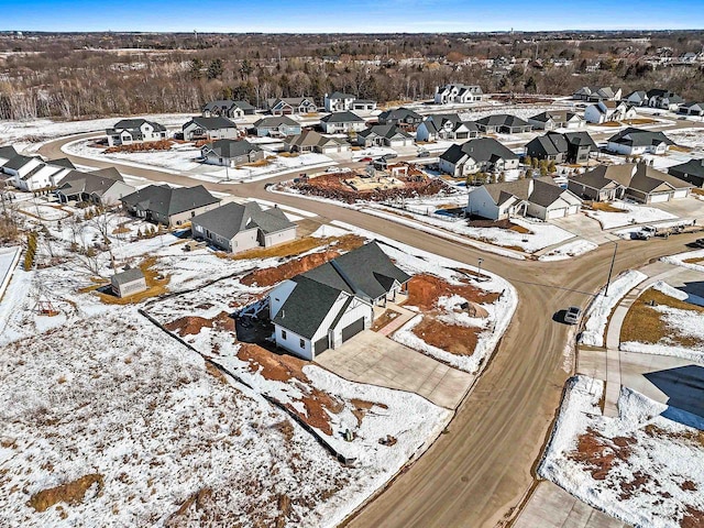 snowy aerial view with a residential view