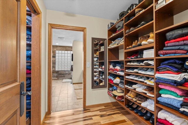 spacious closet featuring light wood-type flooring