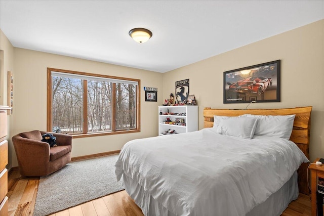 bedroom featuring baseboards and wood finished floors