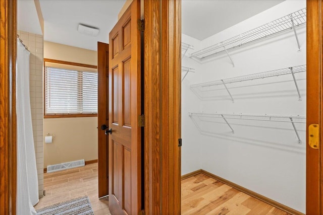 interior space featuring light wood-type flooring and visible vents