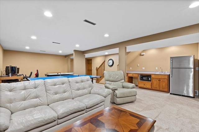 living area featuring recessed lighting, light colored carpet, visible vents, stairway, and wet bar