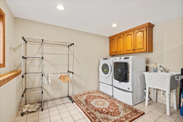 clothes washing area with light tile patterned flooring, independent washer and dryer, cabinet space, and recessed lighting