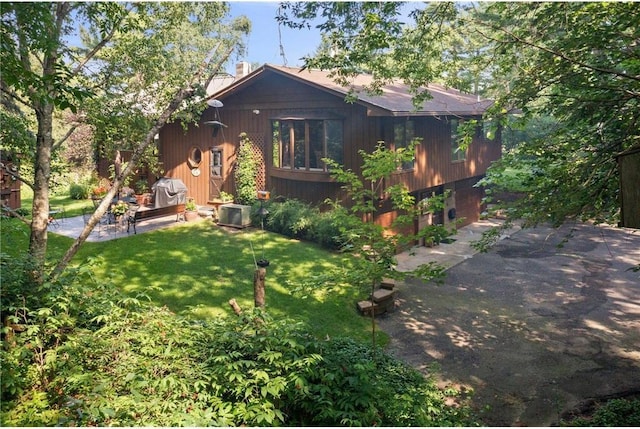 115 Pine Crest Rd, Balsam Lake, WI 54810 - rear view of property featuring a yard and a chimney