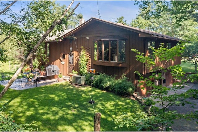 115 Pine Crest Rd, Balsam Lake, WI 54810 - rear view of house featuring a patio and a lawn