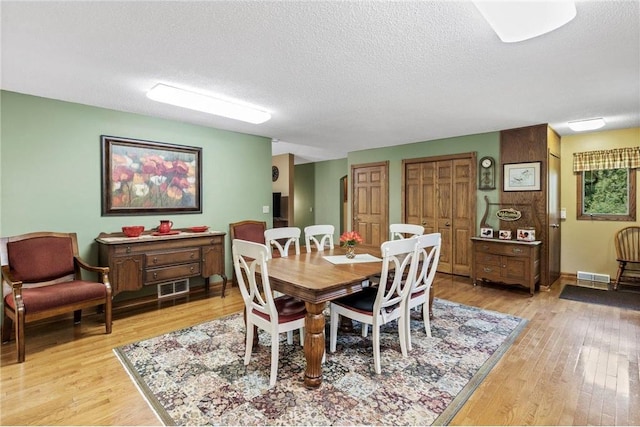 115 Pine Crest Rd, Balsam Lake, WI 54810 - dining space featuring light wood finished floors, visible vents, and a textured ceiling