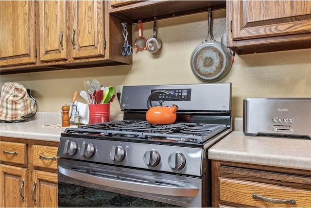 115 Pine Crest Rd, Balsam Lake, WI 54810 - kitchen featuring brown cabinets, gas range, and light countertops