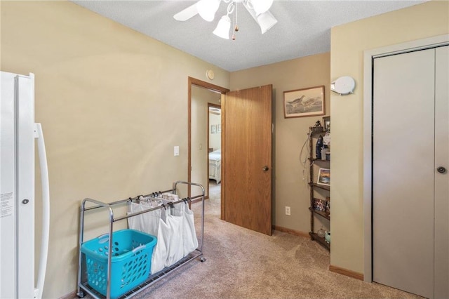 115 Pine Crest Rd, Balsam Lake, WI 54810 - carpeted bedroom with a closet, freestanding refrigerator, ceiling fan, a textured ceiling, and baseboards