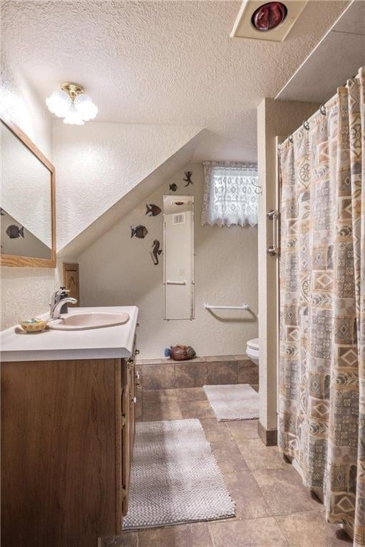 115 Pine Crest Rd, Balsam Lake, WI 54810 - bathroom featuring toilet, a textured wall, a textured ceiling, and vanity