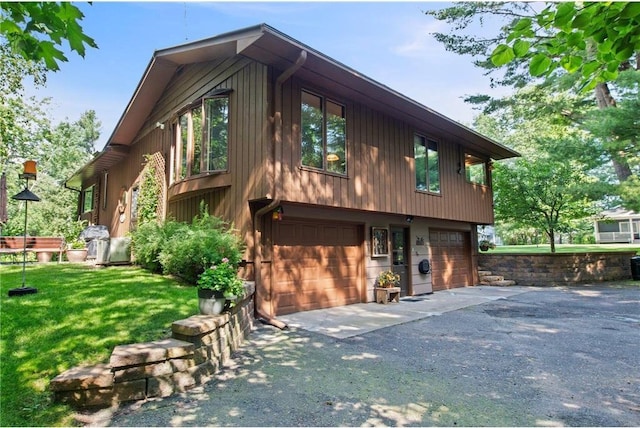115 Pine Crest Rd, Balsam Lake, WI 54810 - exterior space with a garage, a front yard, and aphalt driveway