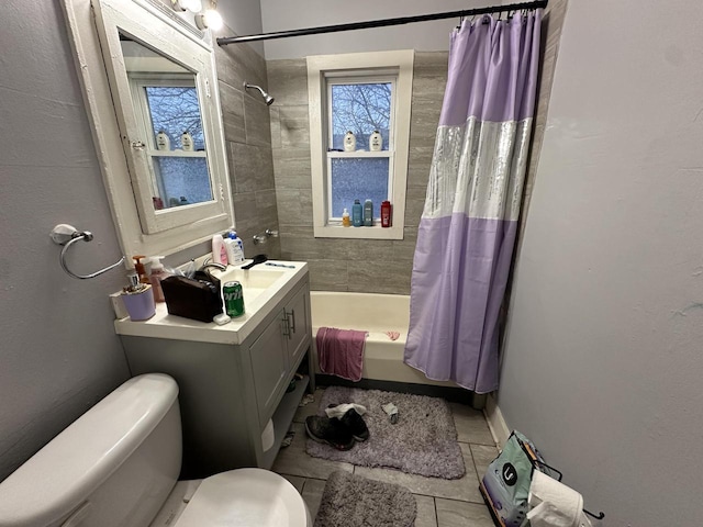 full bathroom with tile patterned flooring, shower / bathtub combination with curtain, toilet, and vanity