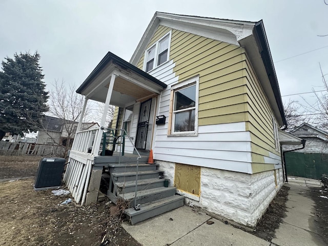 view of front of home with covered porch and cooling unit