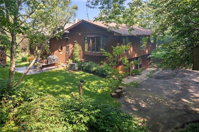 rear view of house with a yard