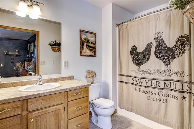 bathroom with toilet, curtained shower, tile patterned flooring, and vanity