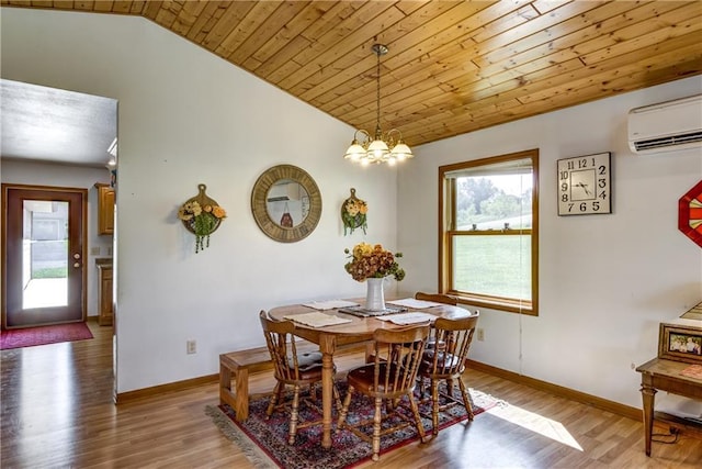 dining area with lofted ceiling, light wood-type flooring, a wall mounted air conditioner, and baseboards