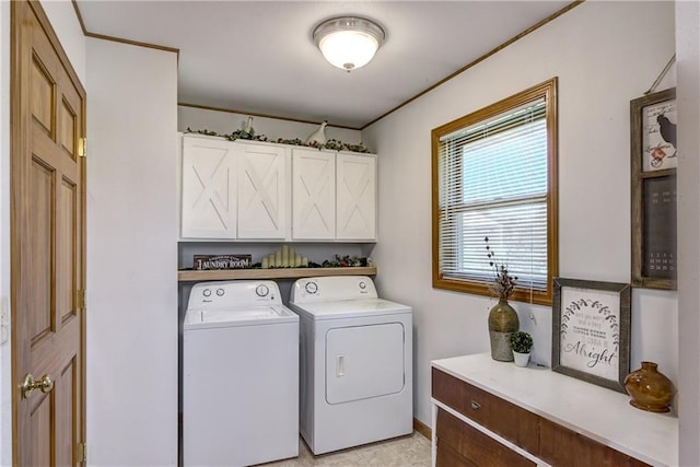 clothes washing area featuring cabinet space and washer and dryer