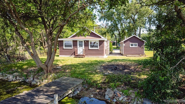 exterior space with entry steps, a front yard, and an outdoor structure