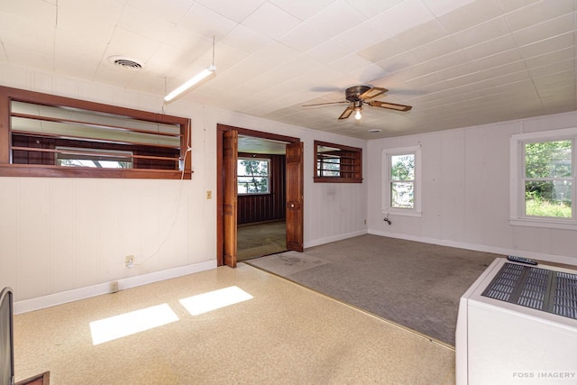 unfurnished room featuring plenty of natural light, visible vents, and baseboards