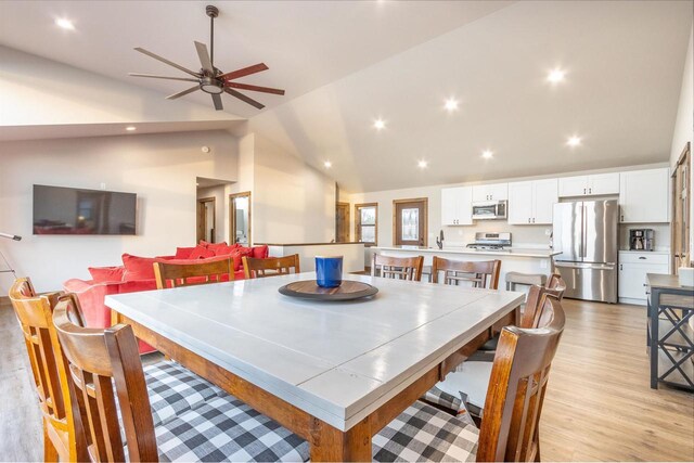 N8791 Lake Cabin Dr, New Lisbon, WI 53950 - dining space featuring lofted ceiling, light wood-style flooring, ceiling fan, and recessed lighting