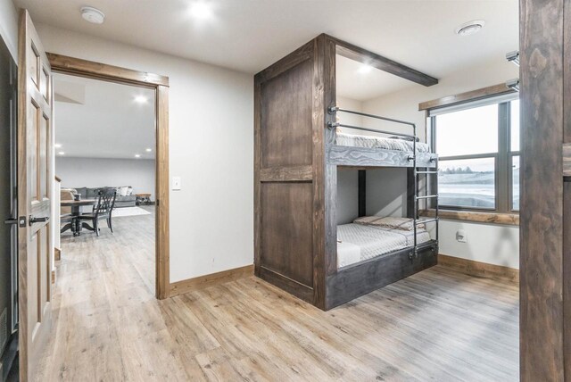 N8791 Lake Cabin Dr, New Lisbon, WI 53950 - unfurnished bedroom with baseboards and light wood-style floors