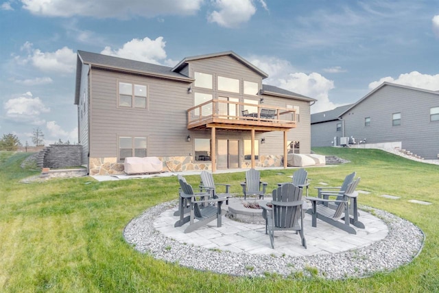 N8791 Lake Cabin Dr, New Lisbon, WI 53950 - back of property featuring a yard, a patio, a fire pit, and a deck