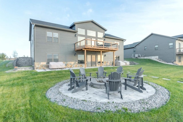 N8791 Lake Cabin Dr, New Lisbon, WI 53950 - rear view of house with a deck, a patio, an outdoor fire pit, and a lawn