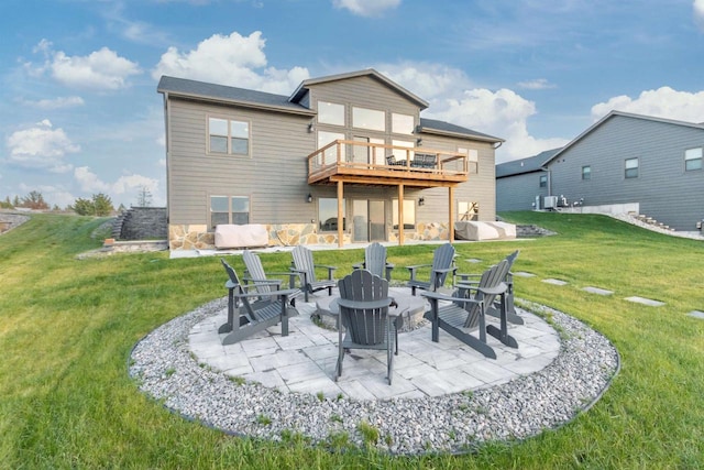 N8791 Lake Cabin Dr, New Lisbon, WI 53950 - rear view of house with a deck, a yard, an outdoor fire pit, and a patio area