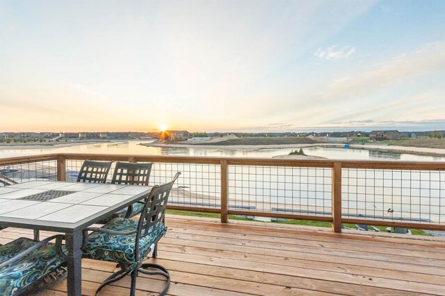 N8791 Lake Cabin Dr, New Lisbon, WI 53950 - wooden deck featuring outdoor dining space and a water view