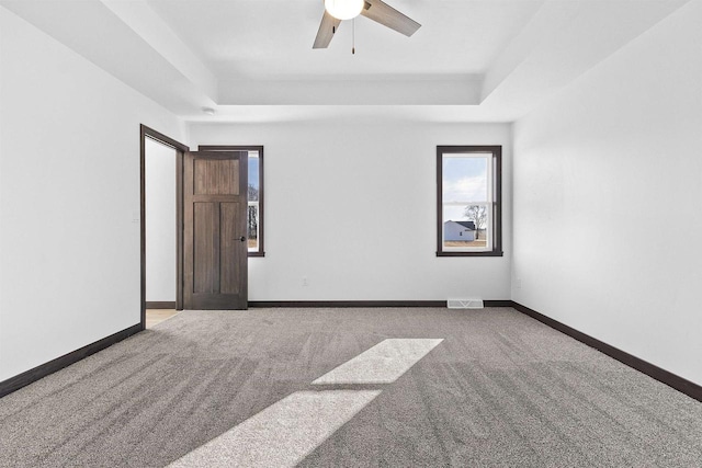 3752 Westpoint Rd, Suamico, WI 54313 - carpeted spare room featuring visible vents, a tray ceiling, and baseboards