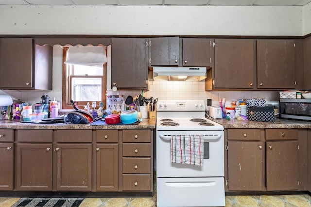 kitchen with under cabinet range hood, tasteful backsplash, stainless steel microwave, and white electric range