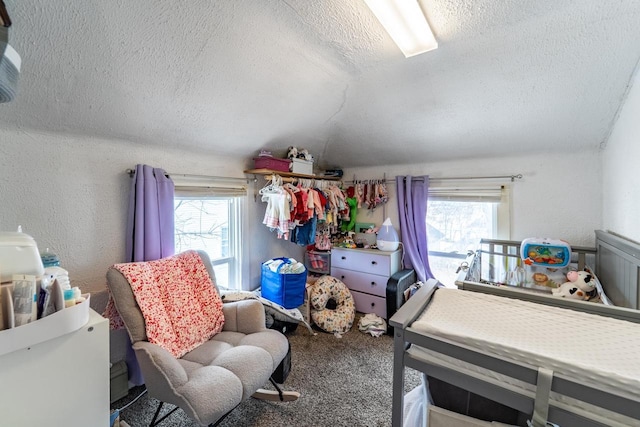 carpeted bedroom with a textured ceiling, a textured wall, and vaulted ceiling