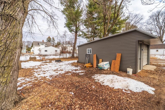 snow covered property with a garage