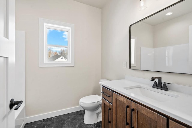 full bathroom with toilet, baseboards, and vanity