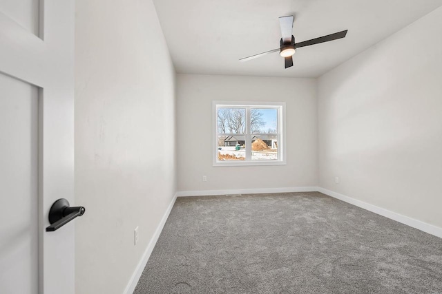 empty room with carpet flooring, ceiling fan, and baseboards