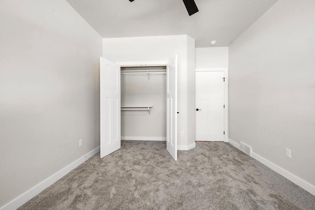 unfurnished bedroom with carpet, a closet, visible vents, and baseboards